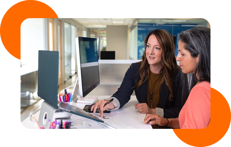 Two colleagues collaborating at a modern office desk